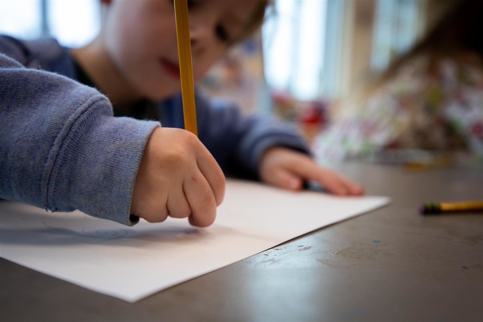 Student writing on a paper.